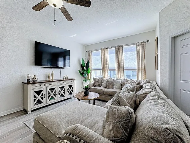 a living room with furniture and kitchen view