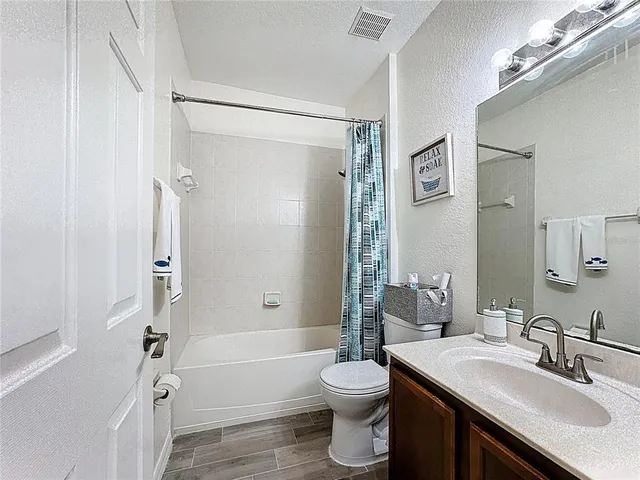 a bedroom with a bed and a chair