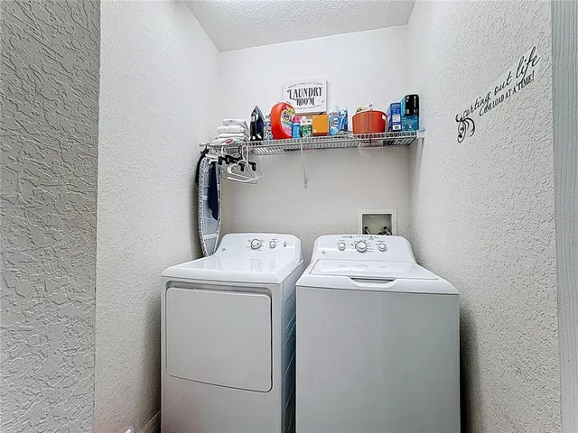 a front view of a house with potted plants