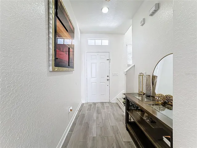 a kitchen with wooden floor and stainless steel appliances