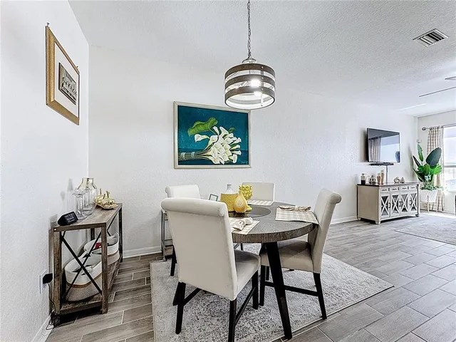 a view of a dining room with furniture wooden floor and a chandelier