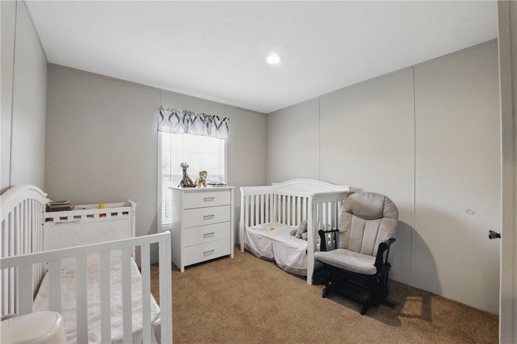 262 Garrison Road Carnesville, GA 30521 - Photo 22 of 59 a bedroom with a bed and a window