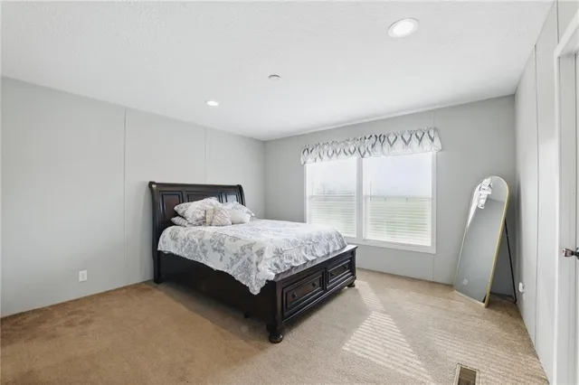 a view of a grassy field with trees