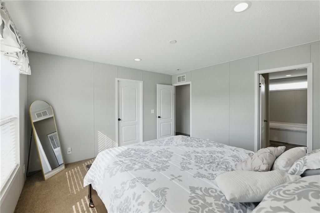 262 Garrison Road Carnesville, GA 30521 - Photo 25 of 59 a bedroom with a bed and a flat tv screen on the dresser