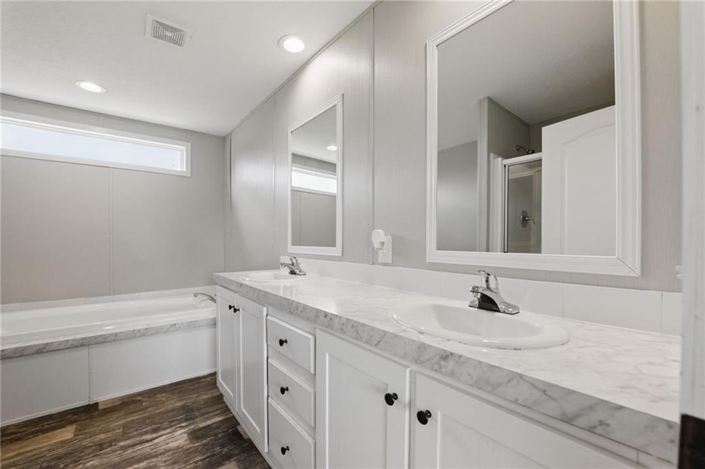 262 Garrison Road Carnesville, GA 30521 - Photo 26 of 59 a bathroom with a double vanity sink and a mirror