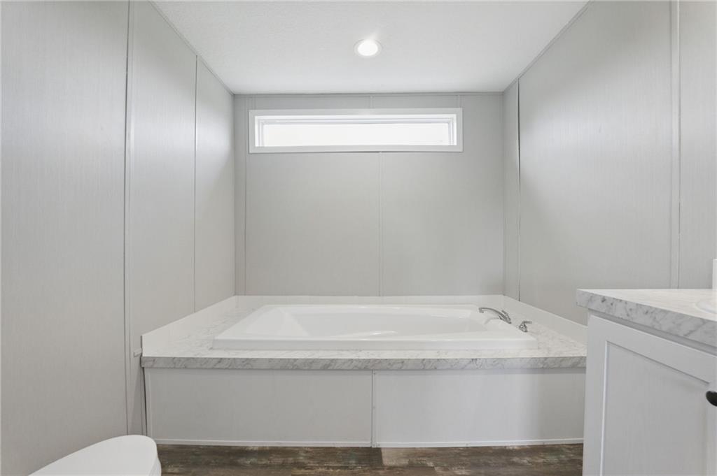 262 Garrison Road Carnesville, GA 30521 - Photo 27 of 59 a bathroom with a granite countertop sink and toilet