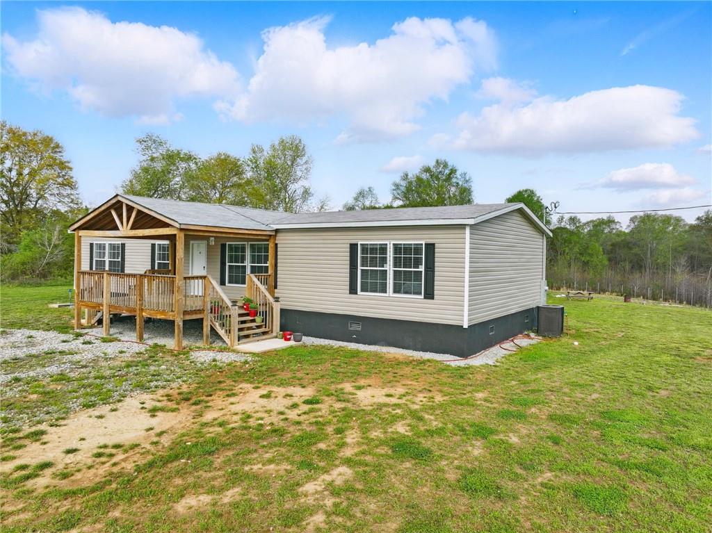 262 Garrison Road Carnesville, GA 30521 - Photo 4 of 59 a view of a house with a yard patio and fire pit