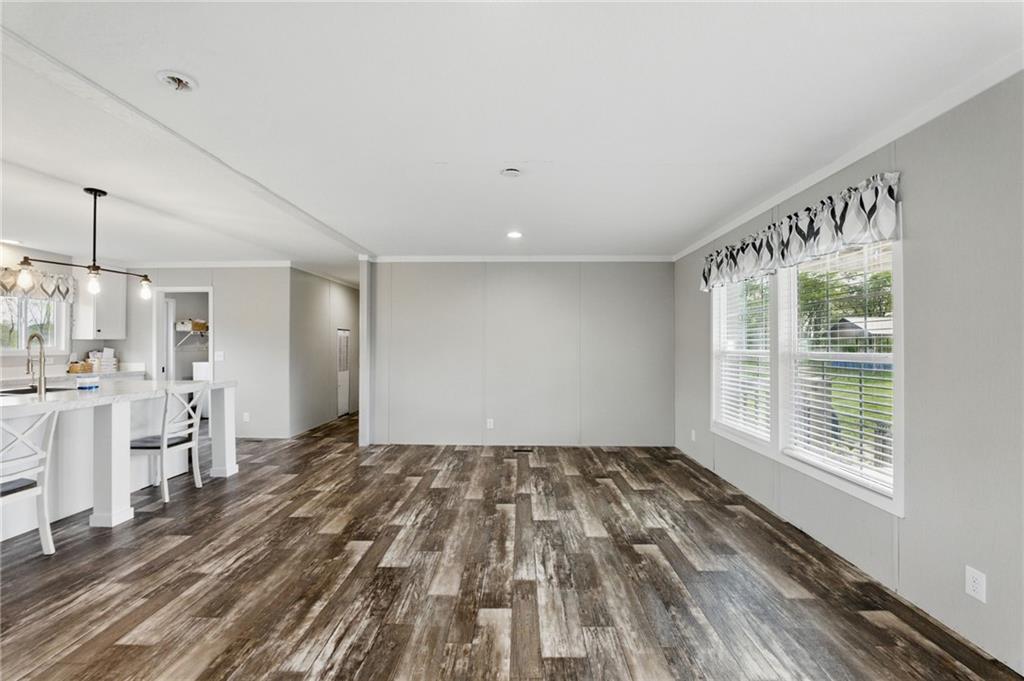262 Garrison Road Carnesville, GA 30521 - Photo 7 of 59 a view of empty room with wooden floor and fan