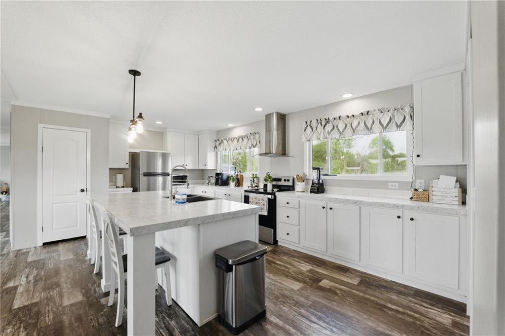 262 Garrison Road Carnesville, GA 30521 - Photo 10 of 59 a kitchen with white cabinets and white appliances