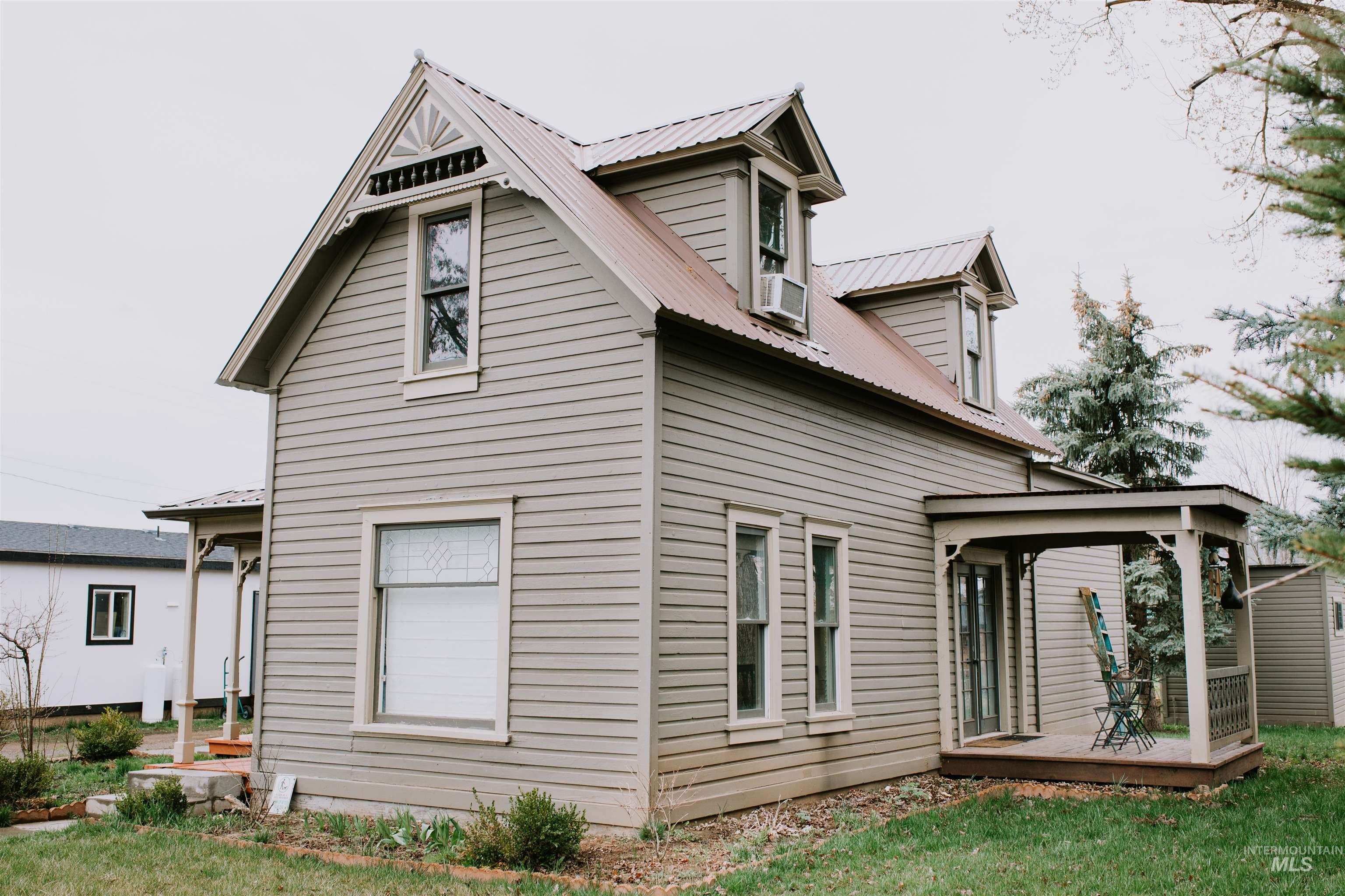 Rear view of house with a metal roof, a deck, and a gazebo