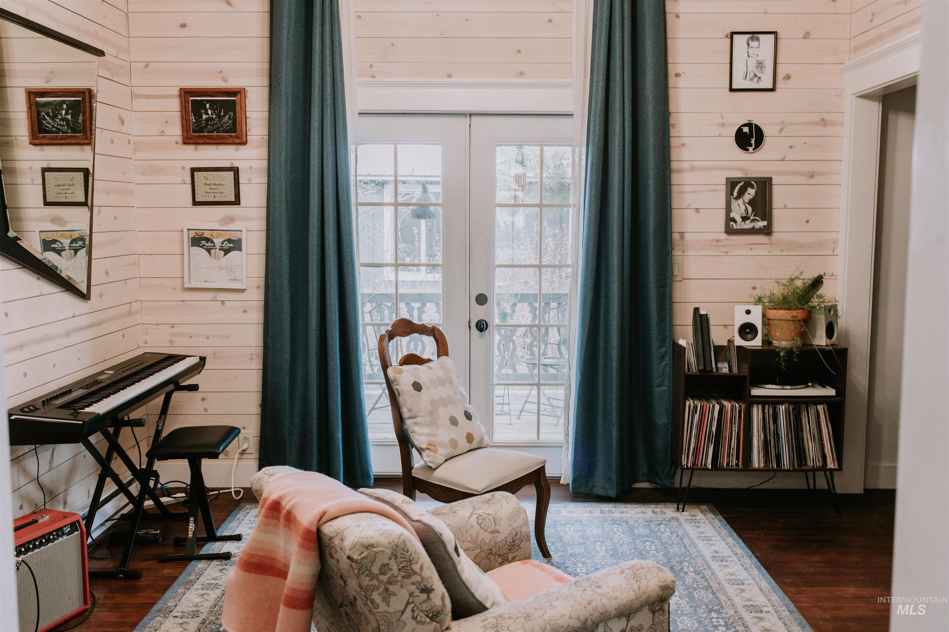104 North Fairfield Street Council, ID 83612 - Photo 13 of 32 Sitting room with wooden walls, dark wood-style floors, and french doors