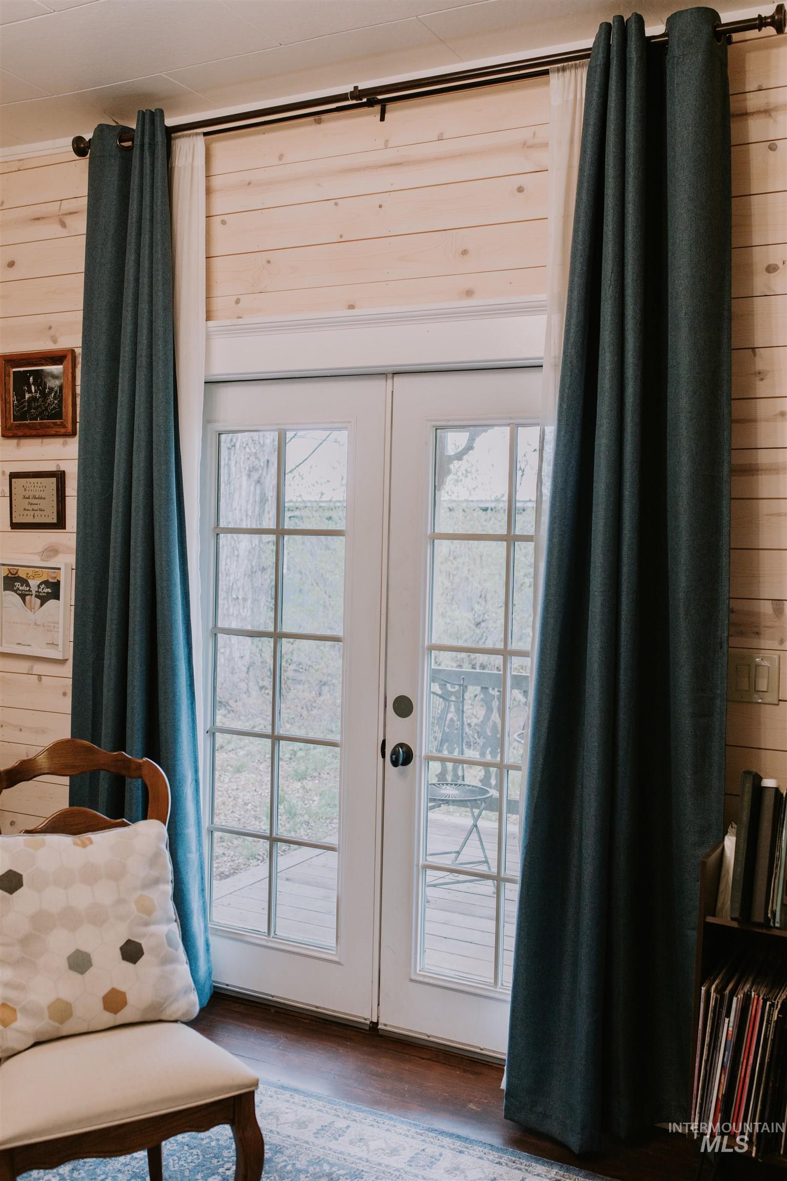 104 North Fairfield Street Council, ID 83612 - Photo 14 of 32 Doorway to outside with french doors, wood finished floors, and wooden walls