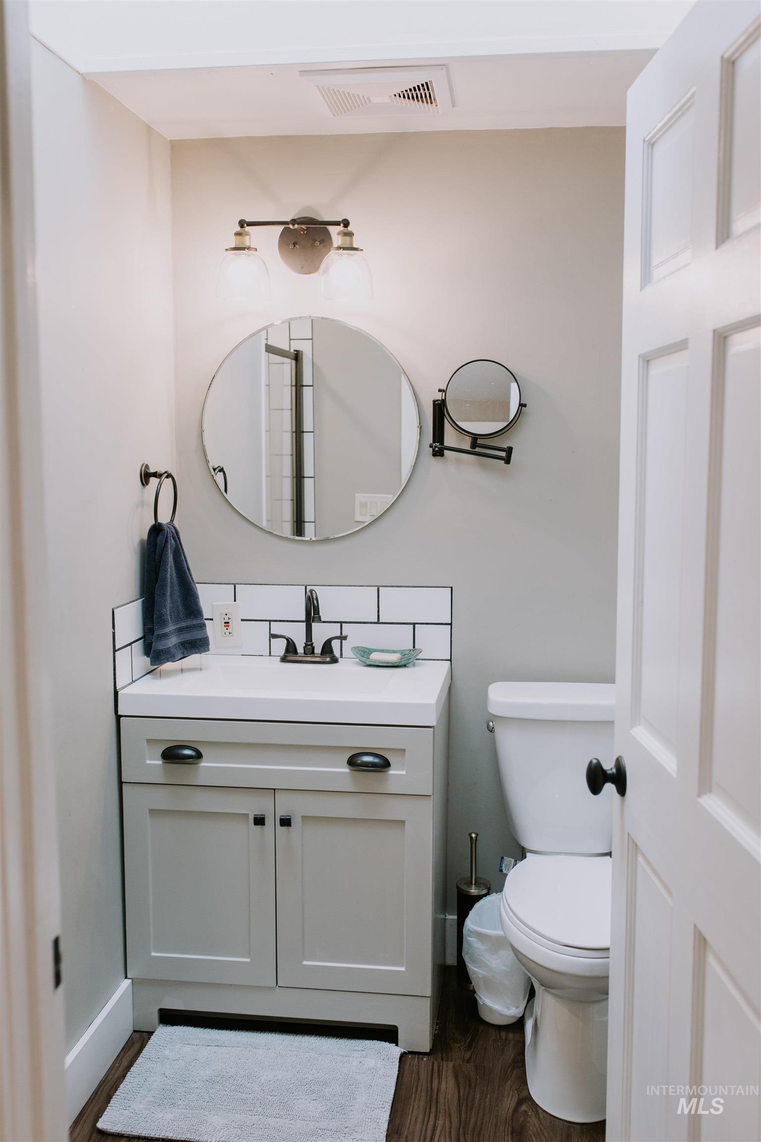 104 North Fairfield Street Council, ID 83612 - Photo 18 of 32 Half bath featuring vanity and dark wood-style floors