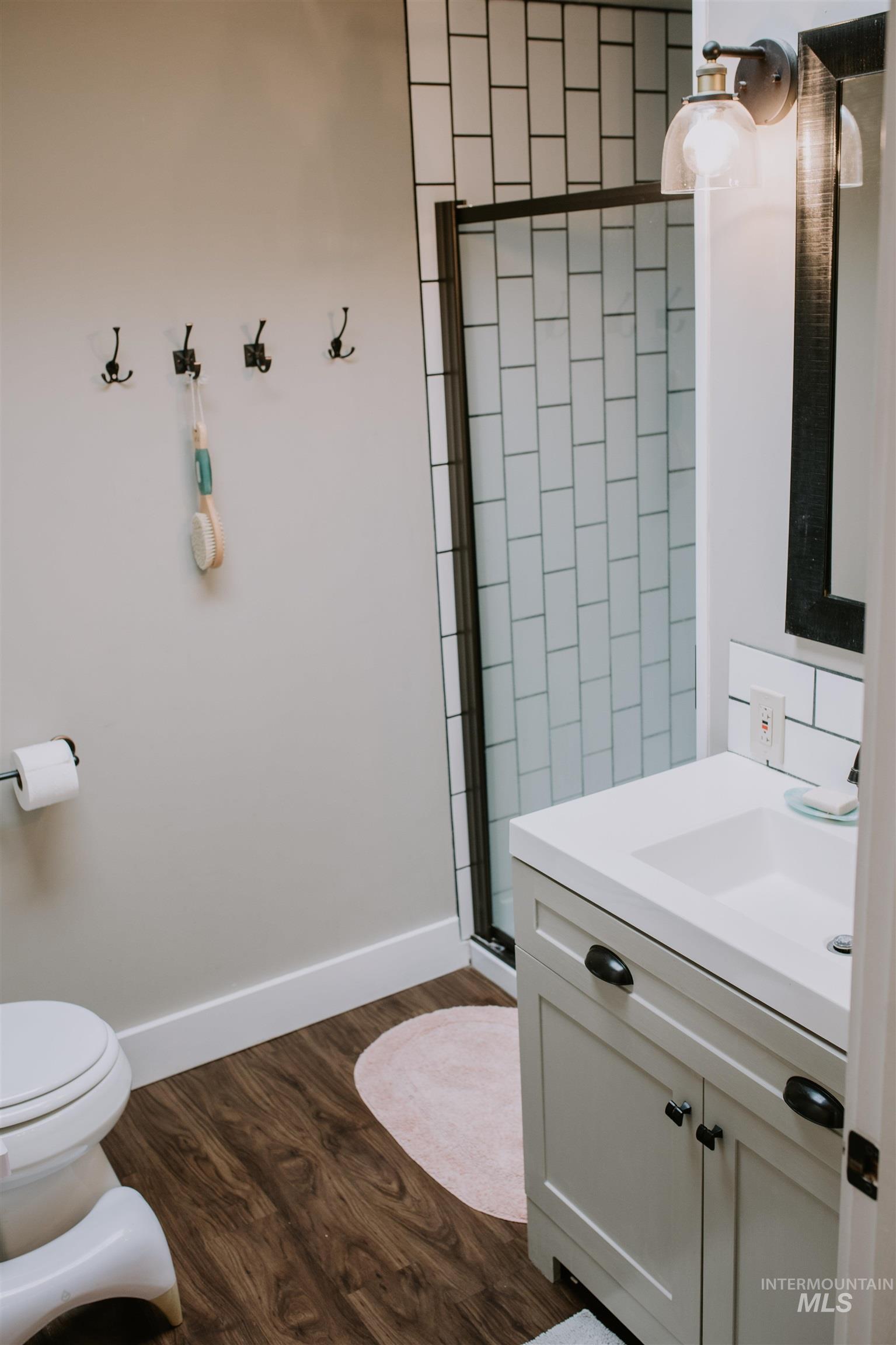 104 North Fairfield Street Council, ID 83612 - Photo 23 of 32 Full bath with a shower stall, dark wood finished floors, and vanity