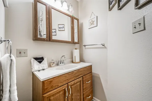 a bathroom with a sink vanity and a mirror