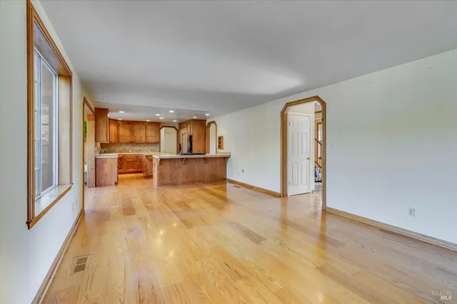 a view of a livingroom with furniture and an empty room