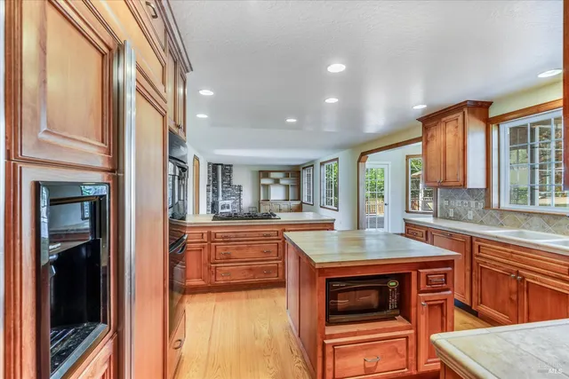 a kitchen with stainless steel appliances granite countertop a stove and a sink