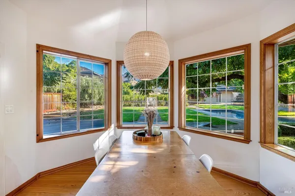 a room with pool table and windows