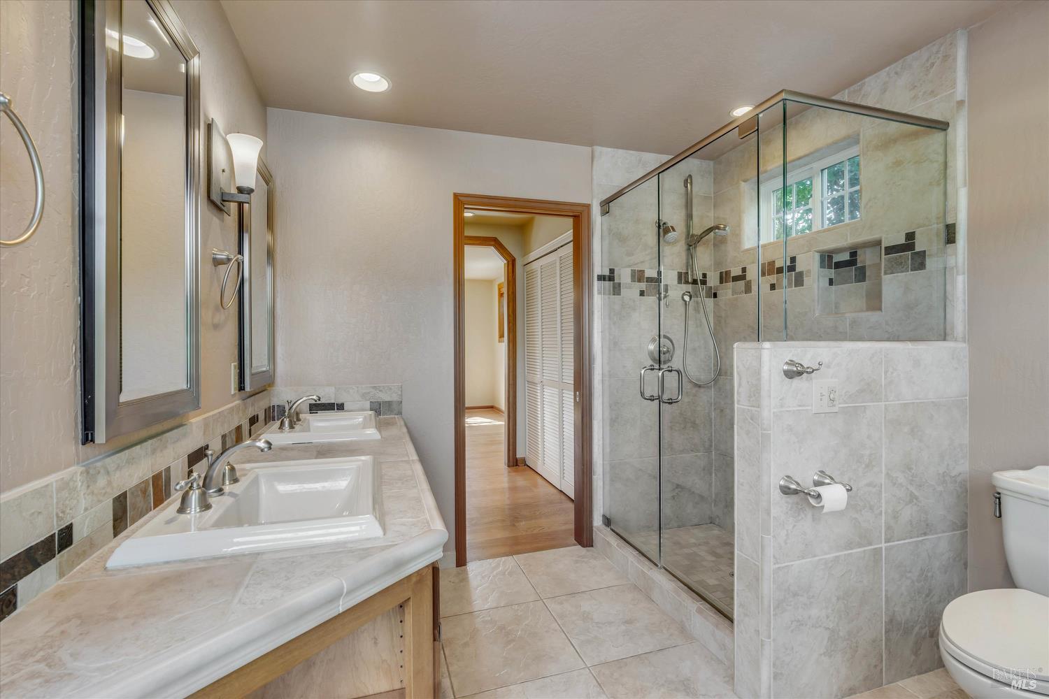 20 Rosedale Road Calistoga, CA 94515 - Photo 26 of 47 a bathroom with a granite countertop sink mirror shower and toilet
