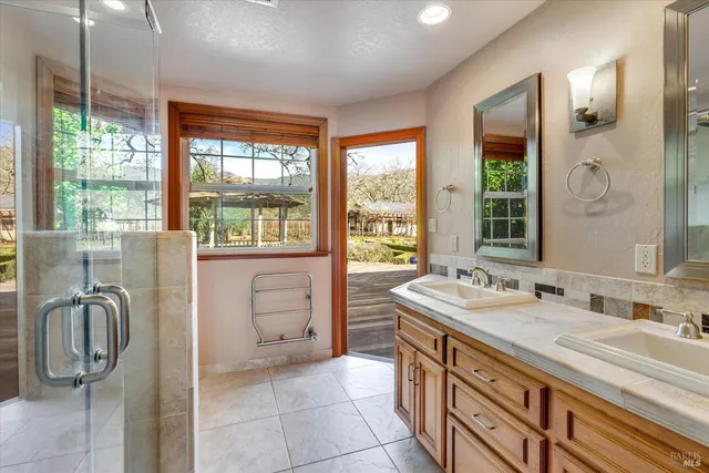 a view of an empty room with a window and a livingroom