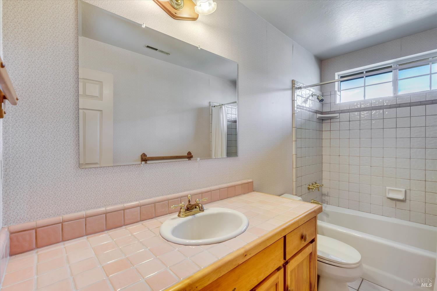 20 Rosedale Road Calistoga, CA 94515 - Photo 34 of 47 a bathroom with a granite countertop sink toilet mirror and bathtub