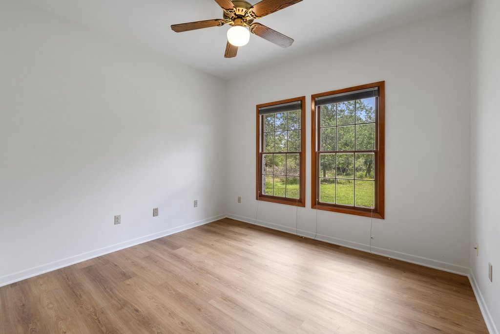 244 Woodway Elgin, TX 78621 - Photo 27 of 40 an empty room with wooden floor fan and windows