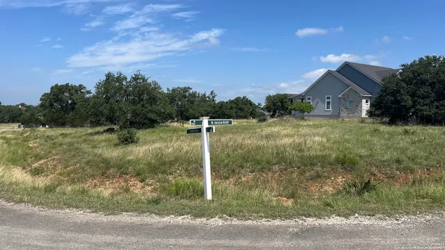a view of a house with a yard and a fountain