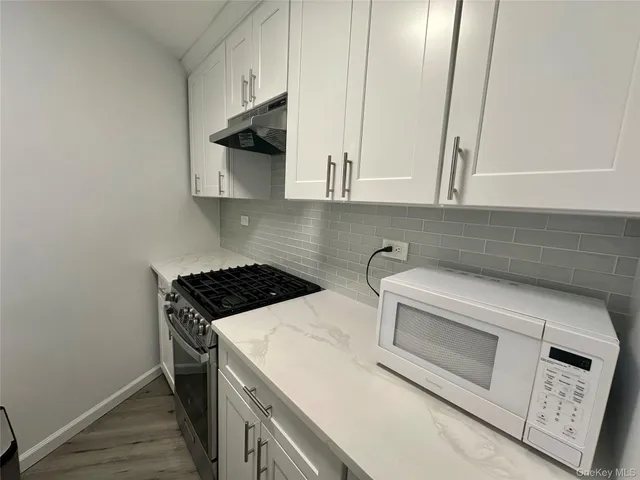 a kitchen with a stove and a microwave