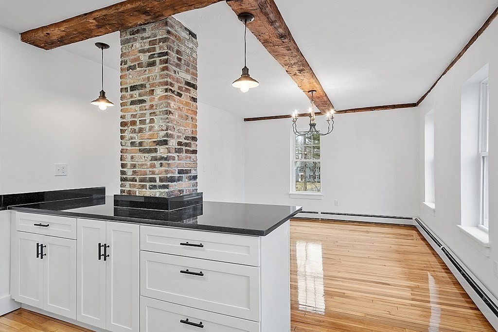 335 Chase Road Lunenburg, MA 01462 - Photo 15 of 42 a kitchen with granite countertop cabinets and window