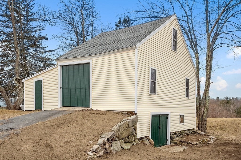 335 Chase Road Lunenburg, MA 01462 - Photo 36 of 42 a front view of a house with a yard and garage