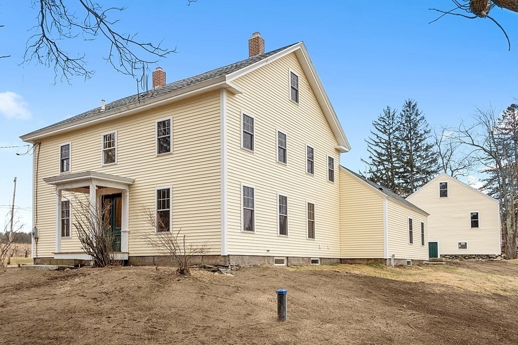 335 Chase Road Lunenburg, MA 01462 - Photo 4 of 42 a view of a white house with a yard