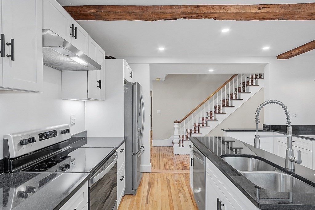 335 Chase Road Lunenburg, MA 01462 - Photo 7 of 42 a kitchen with granite countertop a stove and a sink