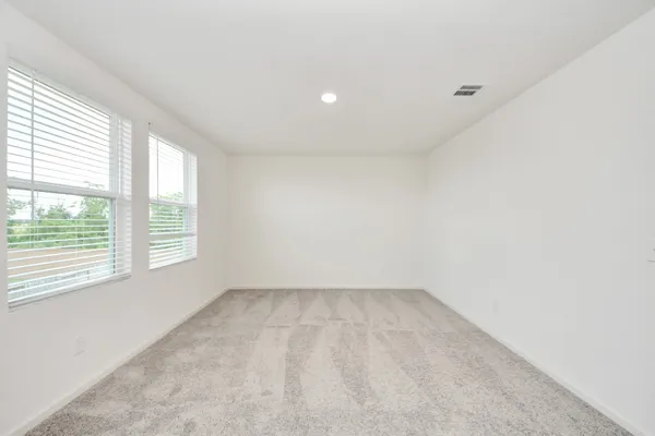 a spacious bathroom with a toilet a sink and a mirror