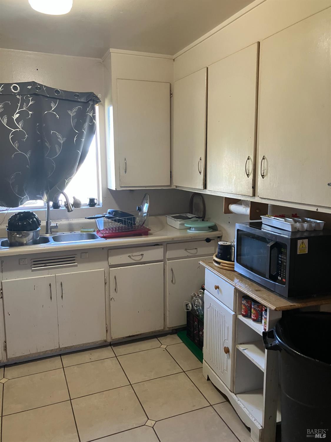 1605 Hearn Avenue Santa Rosa, CA 95407 - Photo 3 of 6 a kitchen with a sink stove and cabinets
