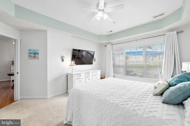 a view of a patio with couches chairs under an umbrella