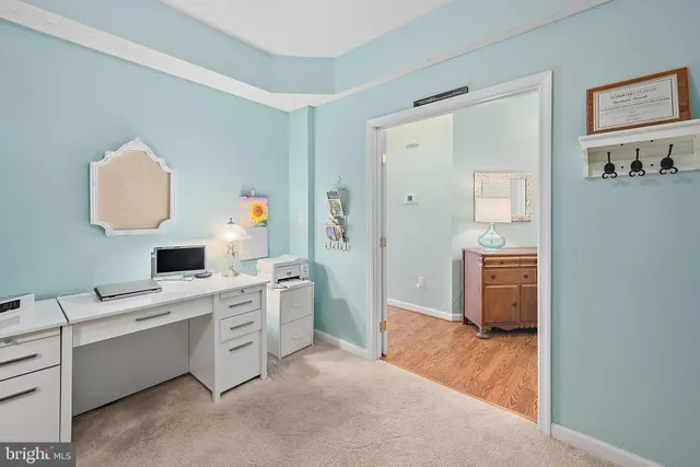 a view of a house with a yard and a large tree