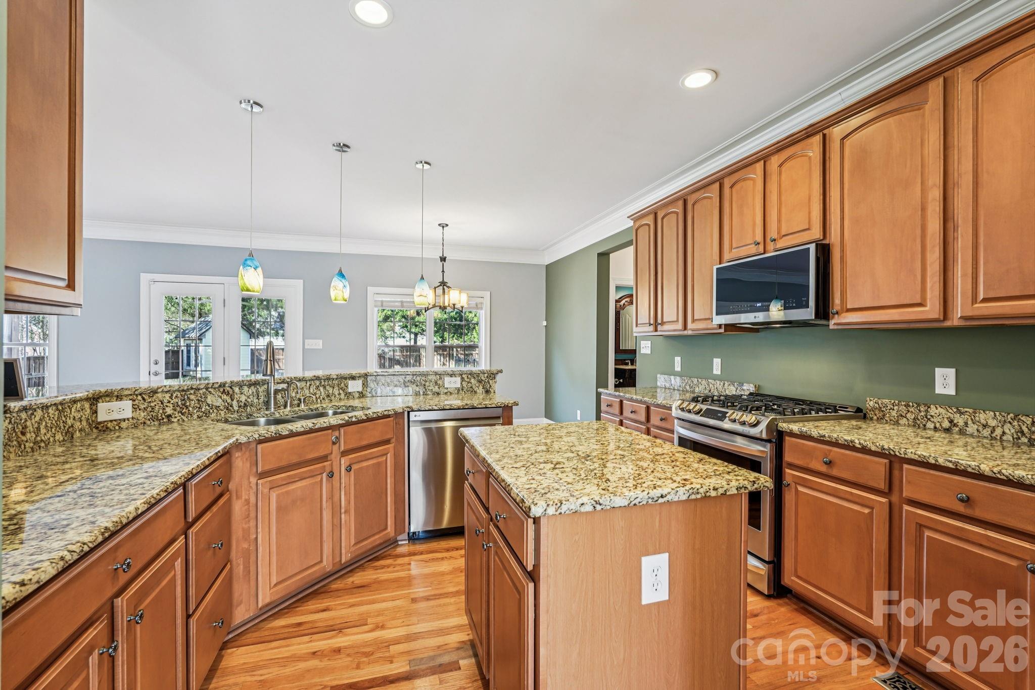 8348 Rocky River Road Harrisburg, NC 28075 - Photo 11 of 47 a kitchen with stainless steel appliances granite countertop a sink stove and cabinets