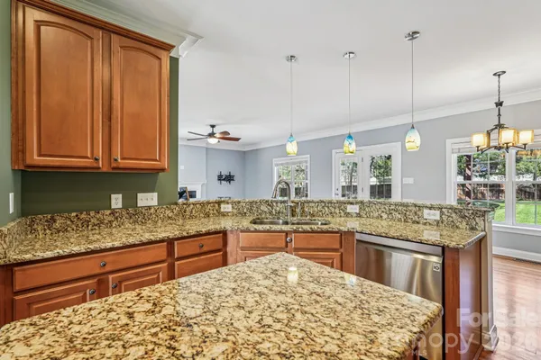a kitchen with stainless steel appliances granite countertop sink stove and cabinets