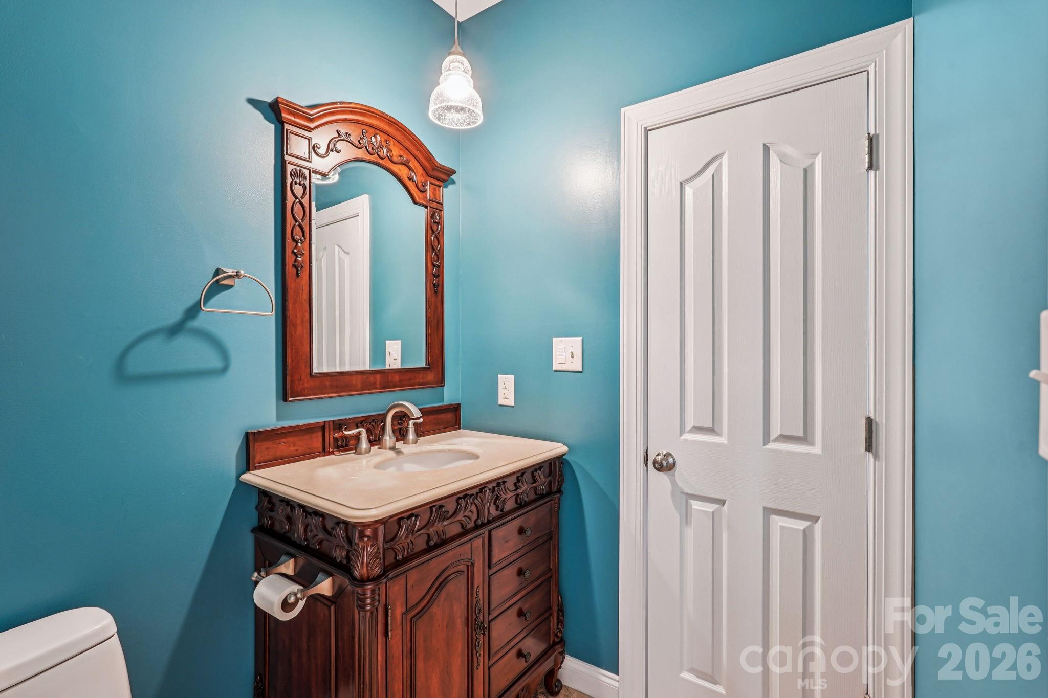 8348 Rocky River Road Harrisburg, NC 28075 - Photo 15 of 47 a bathroom with a sink and a mirror
