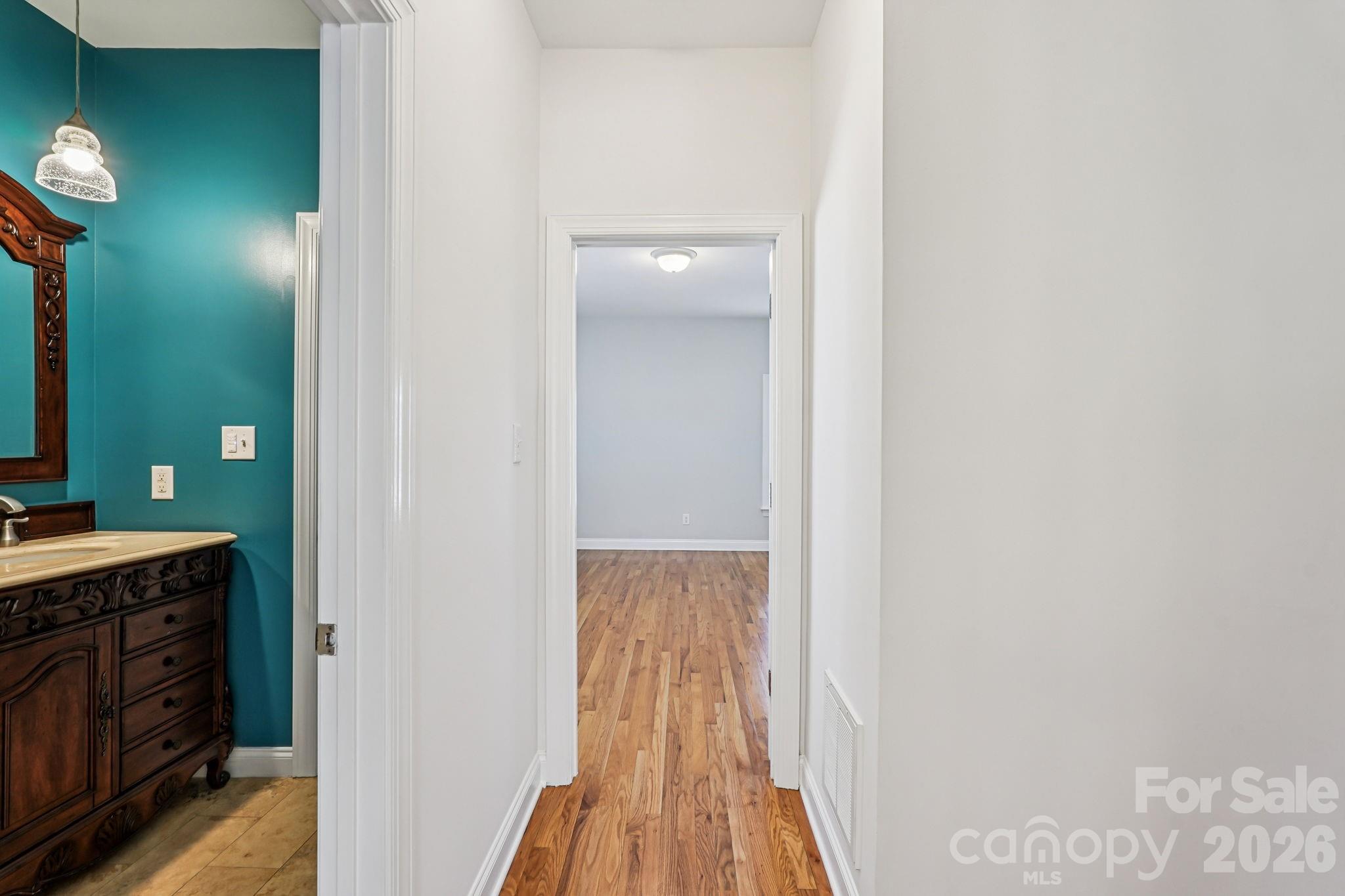 8348 Rocky River Road Harrisburg, NC 28075 - Photo 16 of 47 a view of a bathroom from the hallway