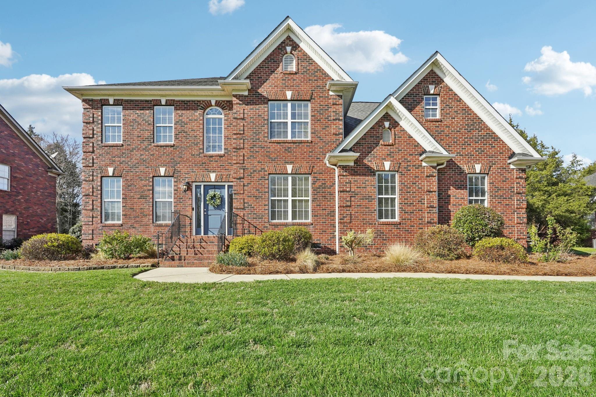 8348 Rocky River Road Harrisburg, NC 28075 - Photo 2 of 47 a front view of a house with a yard and plants