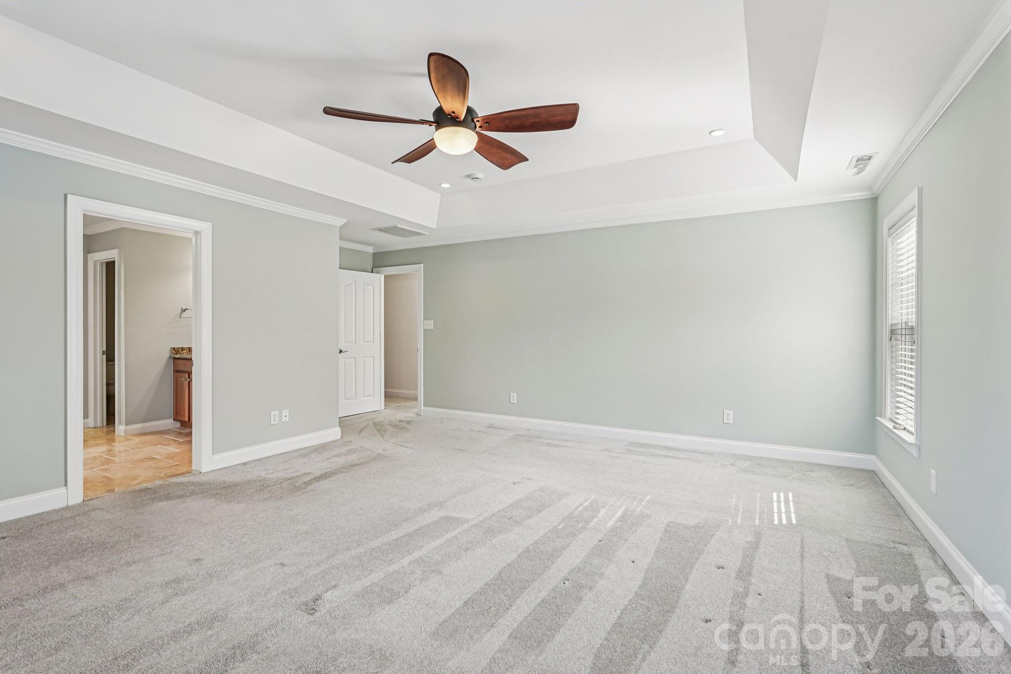 8348 Rocky River Road Harrisburg, NC 28075 - Photo 24 of 47 a view of an empty room with wooden floor and a ceiling fan