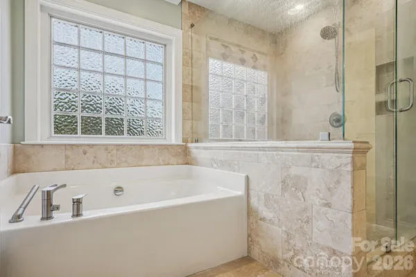 a bathroom with a bathtub and shower