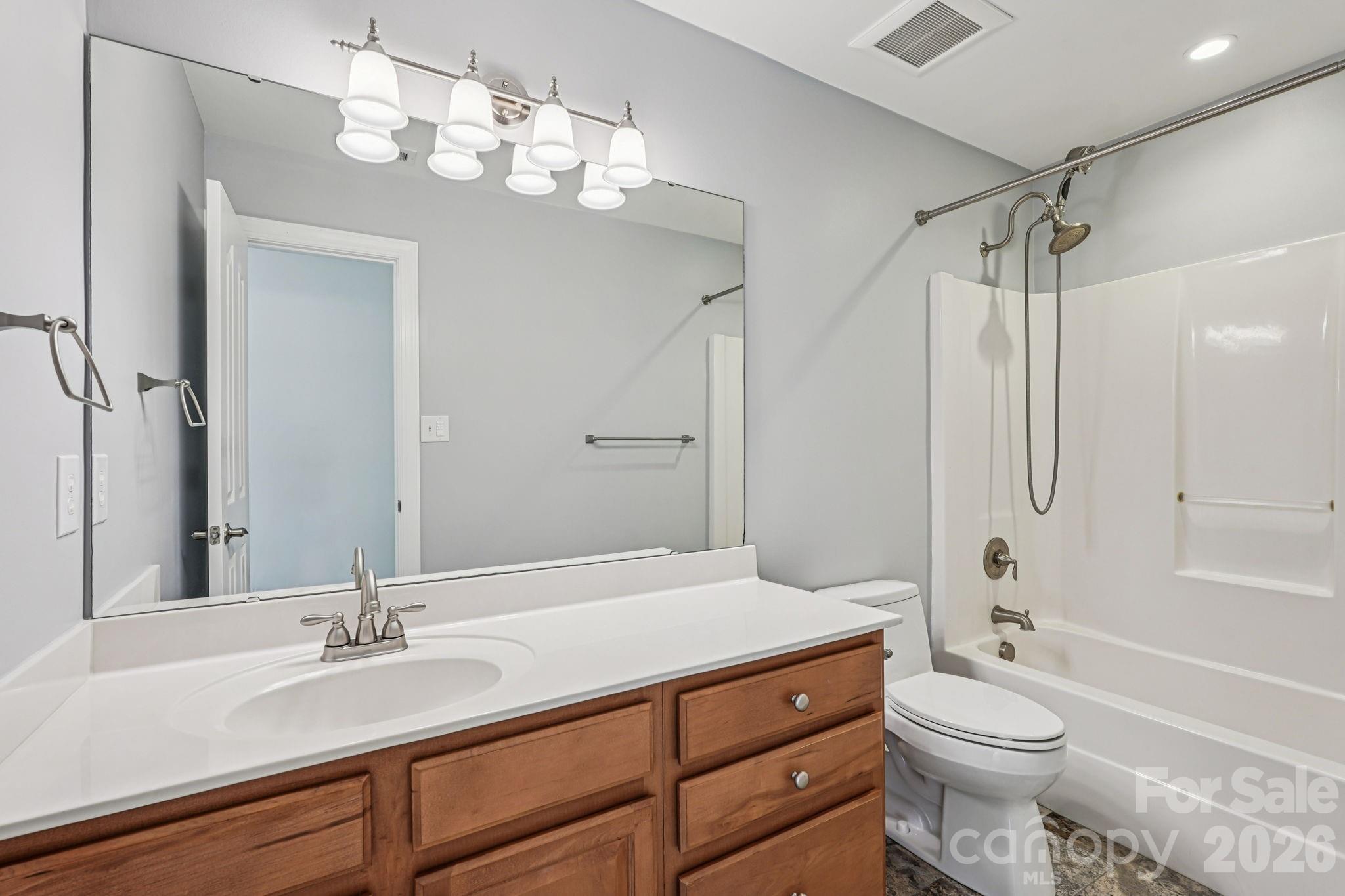 8348 Rocky River Road Harrisburg, NC 28075 - Photo 29 of 47 a bathroom with a sink a toilet and shower