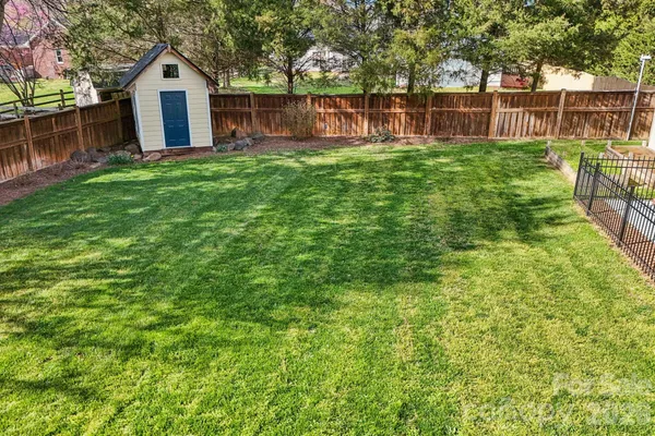 a front view of a house with yard and green space