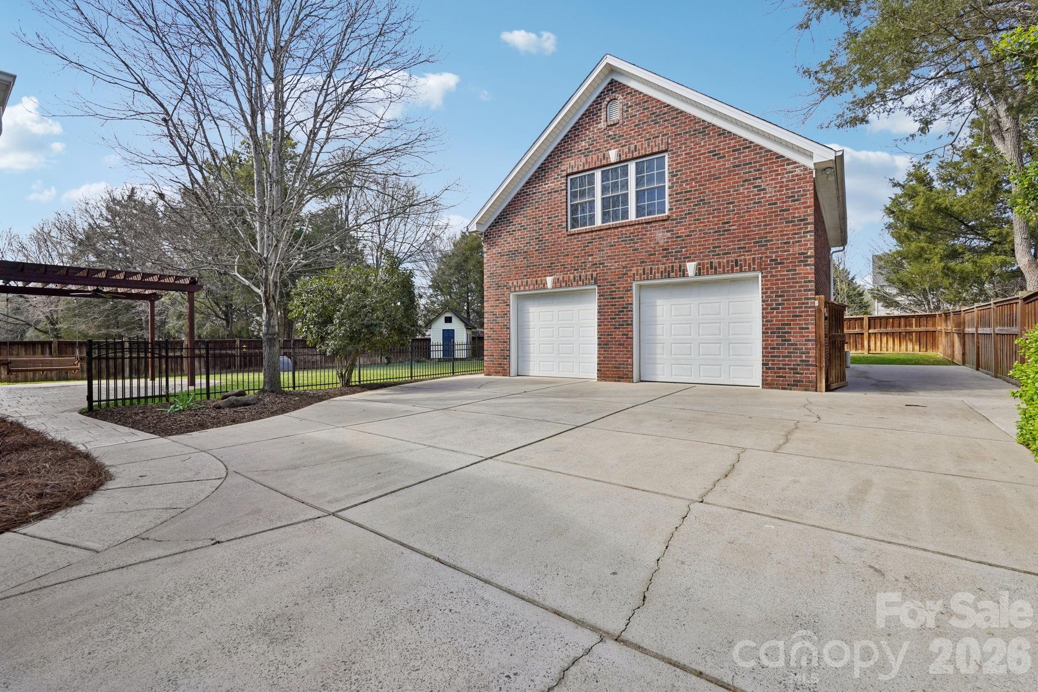 8348 Rocky River Road Harrisburg, NC 28075 - Photo 35 of 47 a front view of a house with a garden