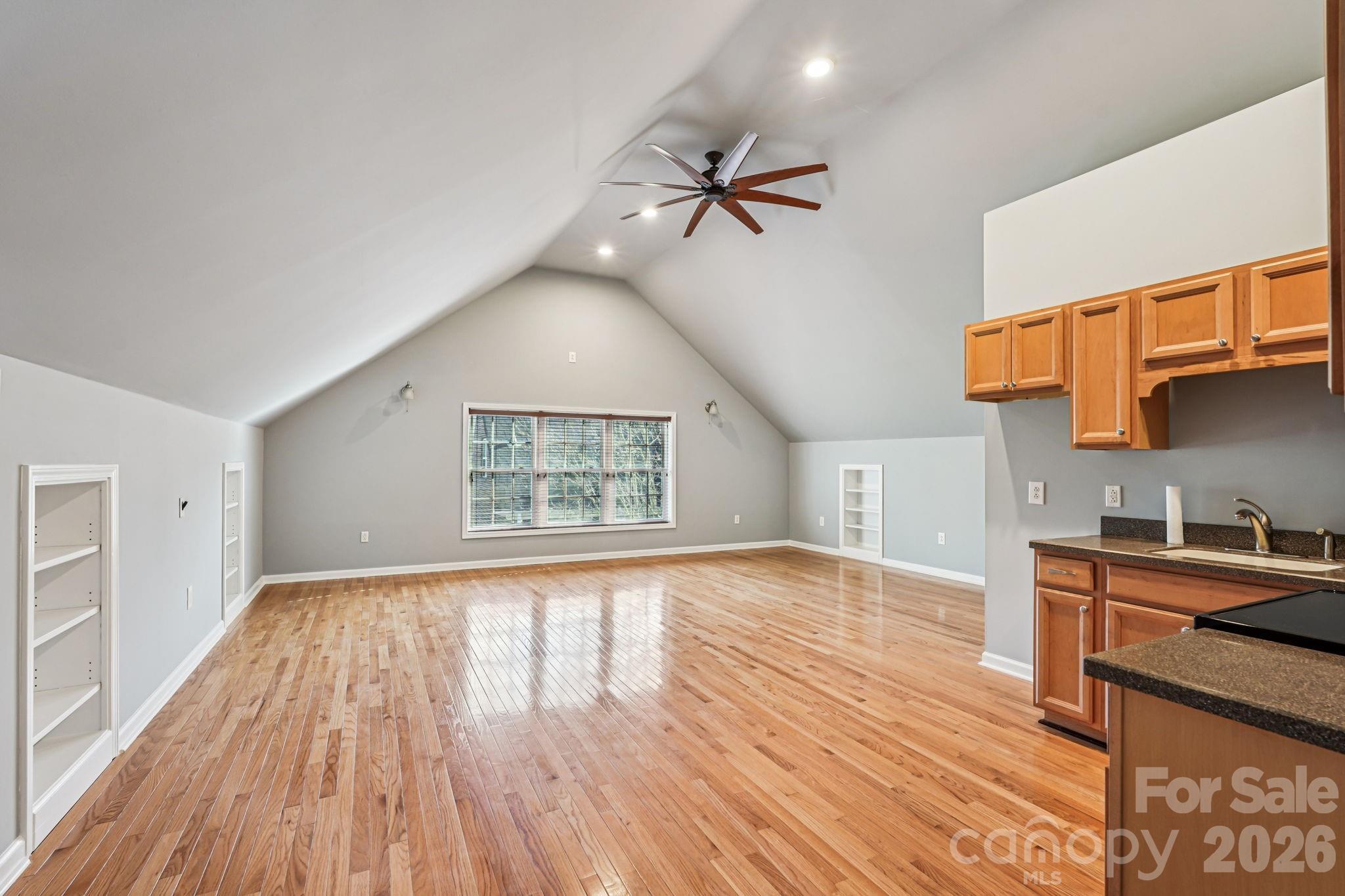 8348 Rocky River Road Harrisburg, NC 28075 - Photo 40 of 47 a view of empty room with wooden floor and fan