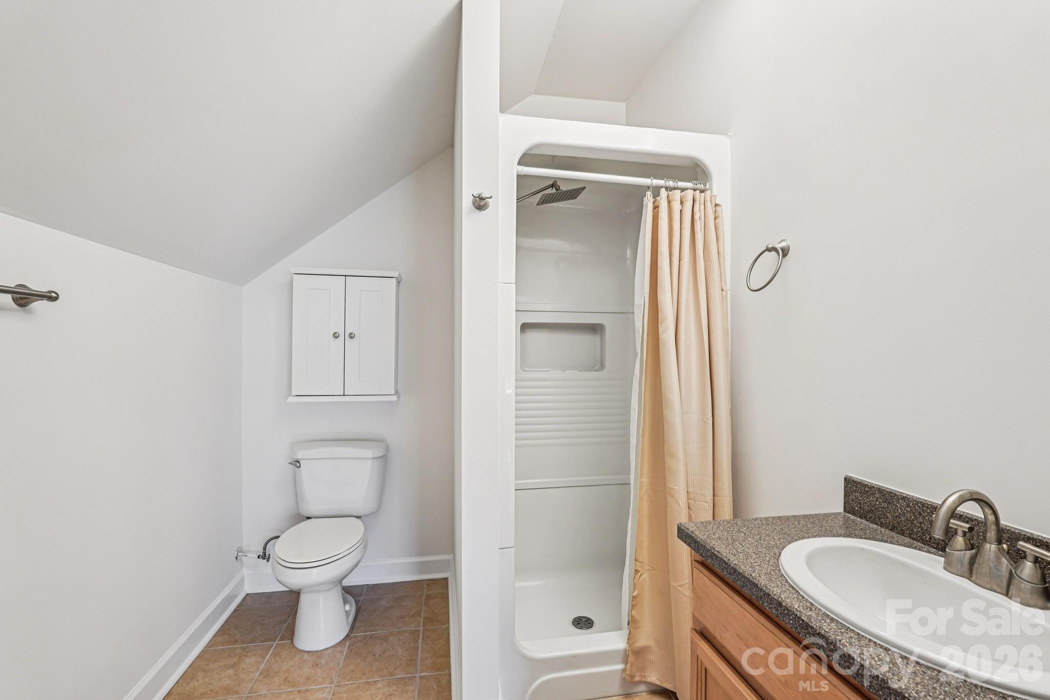 8348 Rocky River Road Harrisburg, NC 28075 - Photo 43 of 47 a bathroom with a granite countertop sink toilet and shower