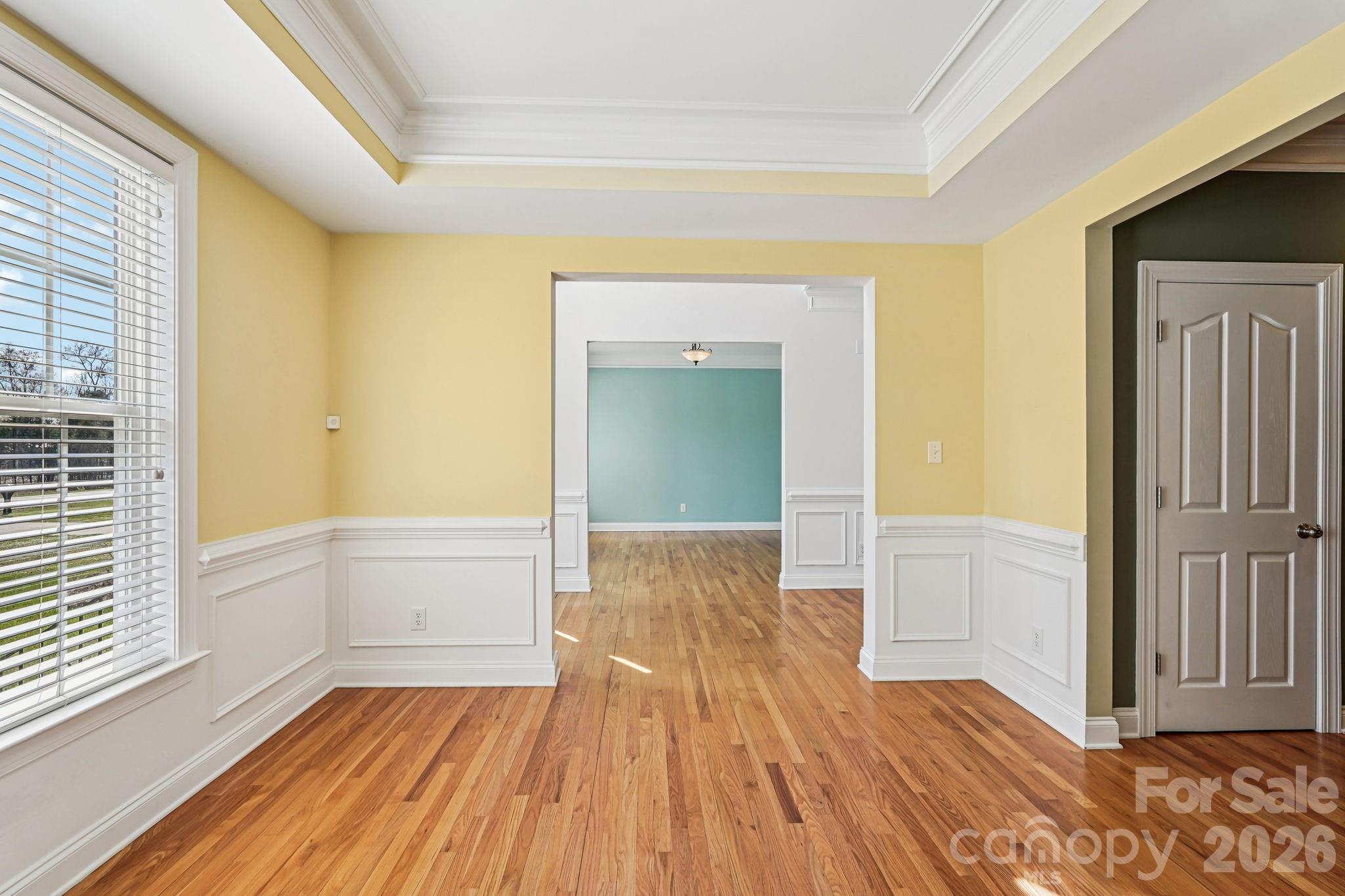 8348 Rocky River Road Harrisburg, NC 28075 - Photo 5 of 47 a view of empty room with wooden floor and fan