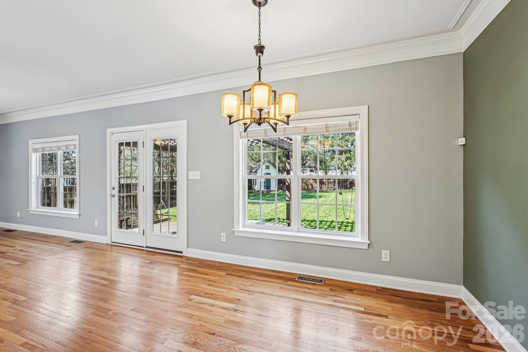 8348 Rocky River Road Harrisburg, NC 28075 - Photo 9 of 47 a view of an empty room with wooden floor and a window